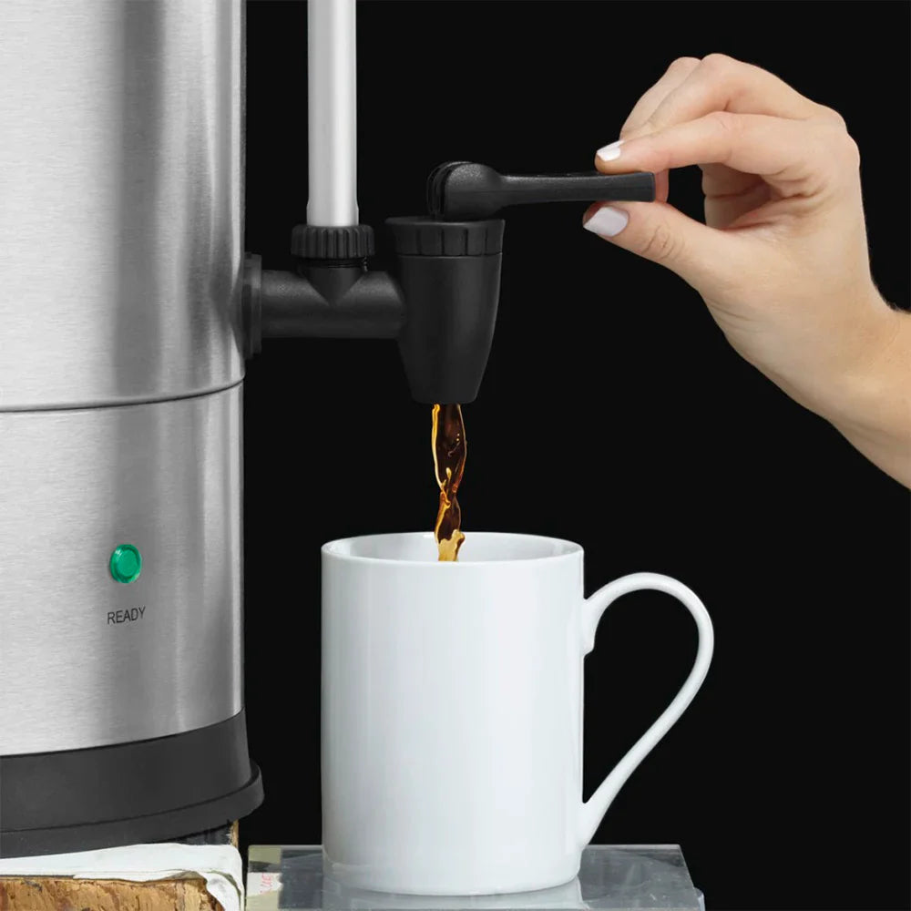 Waring WCU110X coffee urn faucet handle pressed to pour coffee into a white mug, close-up