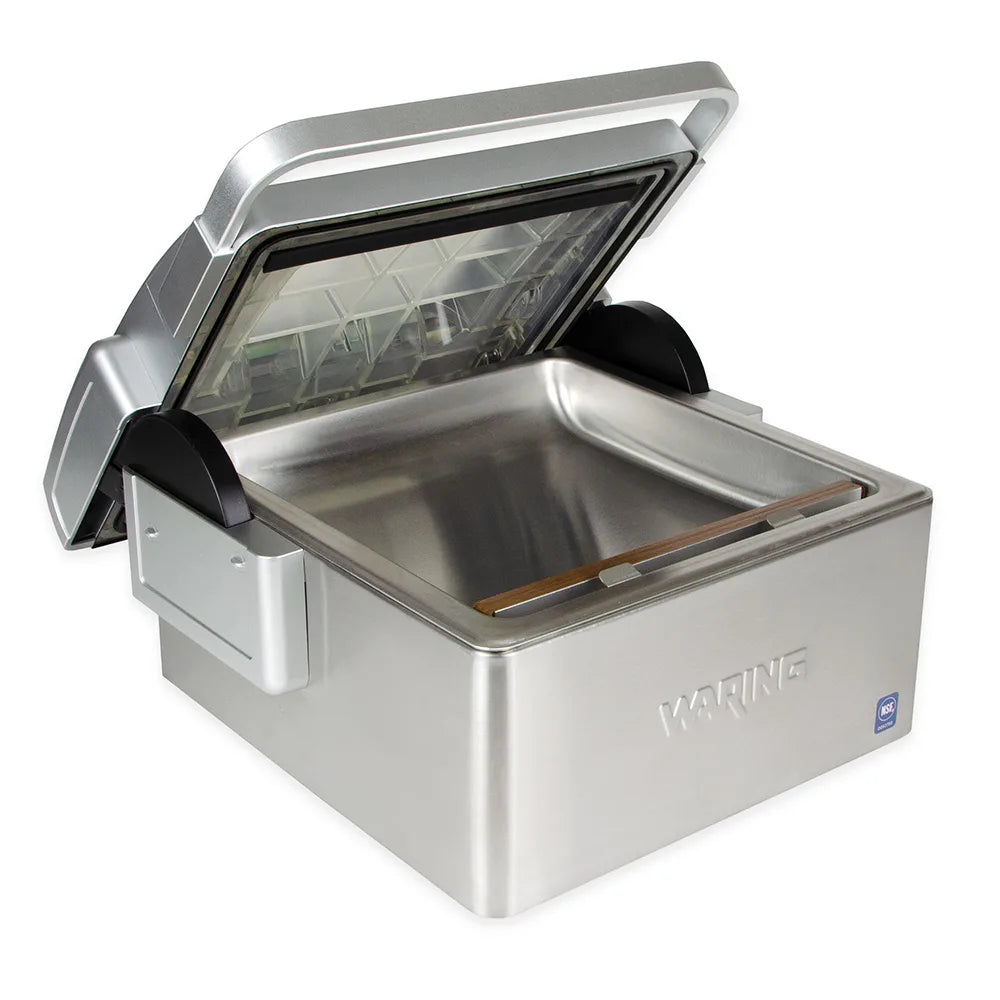 Waring WCV300 chamber vacuum sealer, lid open showing the stainless steel chamber and seal bar