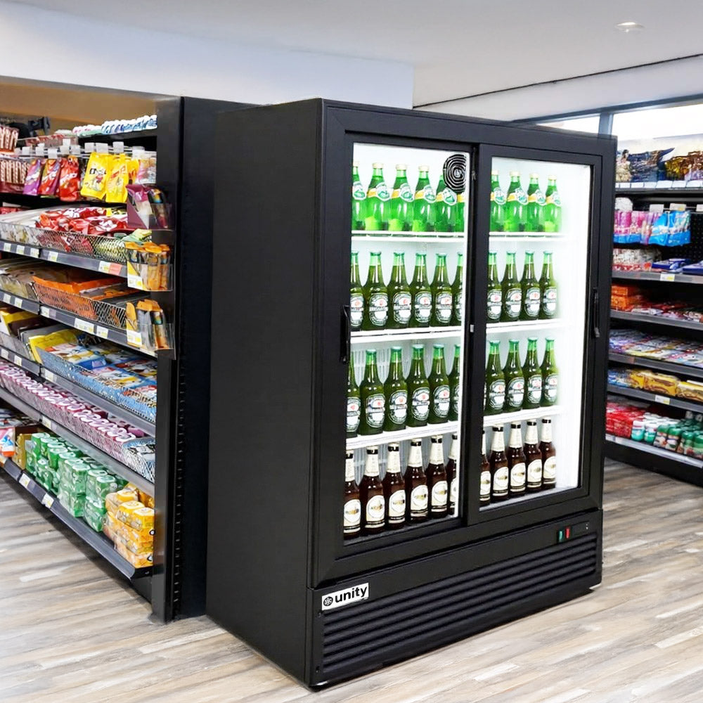 Unity BLU-36SB sliding glass door merchandiser refrigerator, stocked with bottles in a store