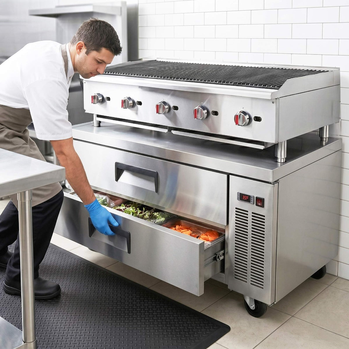 Coldline CB60 2-drawer refrigerated chef base, in use under a countertop charbroiler, lower drawer open (representative image)