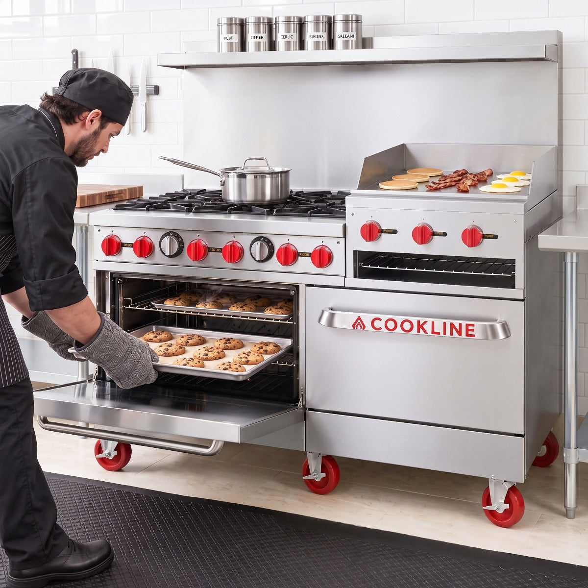 Cookline CR60-24RG-NG 60" commercial gas range, in use, a chef taking cookies out of the oven