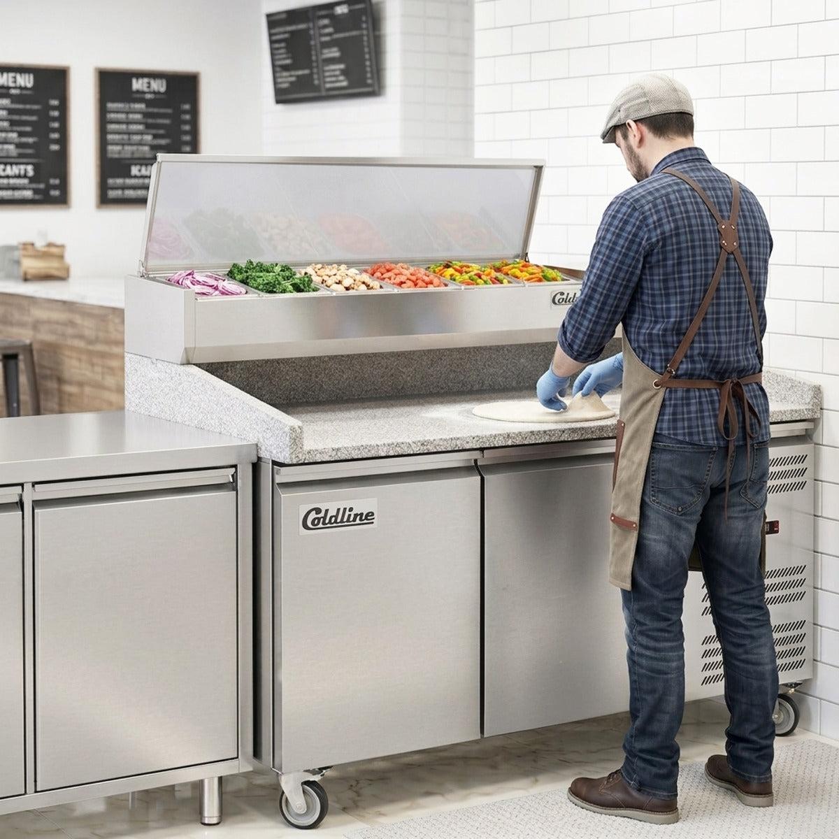 Coldline PDR-60-SS refrigerated pizza prep table with marble top, in use in a pizzeria (representative image)