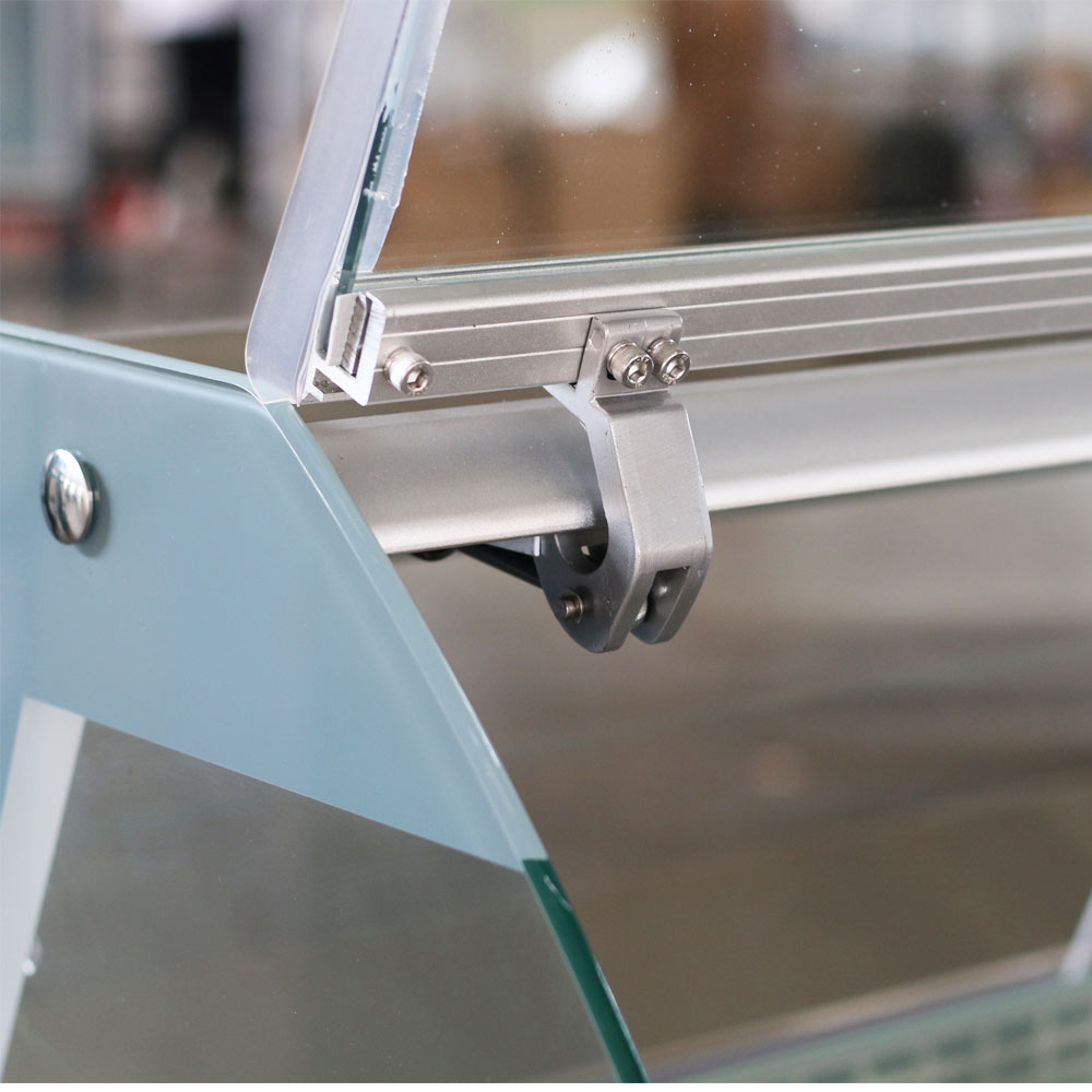 Coldline SDC48 curved glass meat deli case, curved glass hinge, close-up