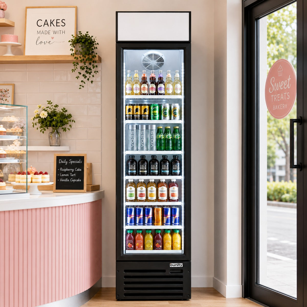 Unity U-17M glass door merchandiser refrigerator, stocked with drinks in a bakery