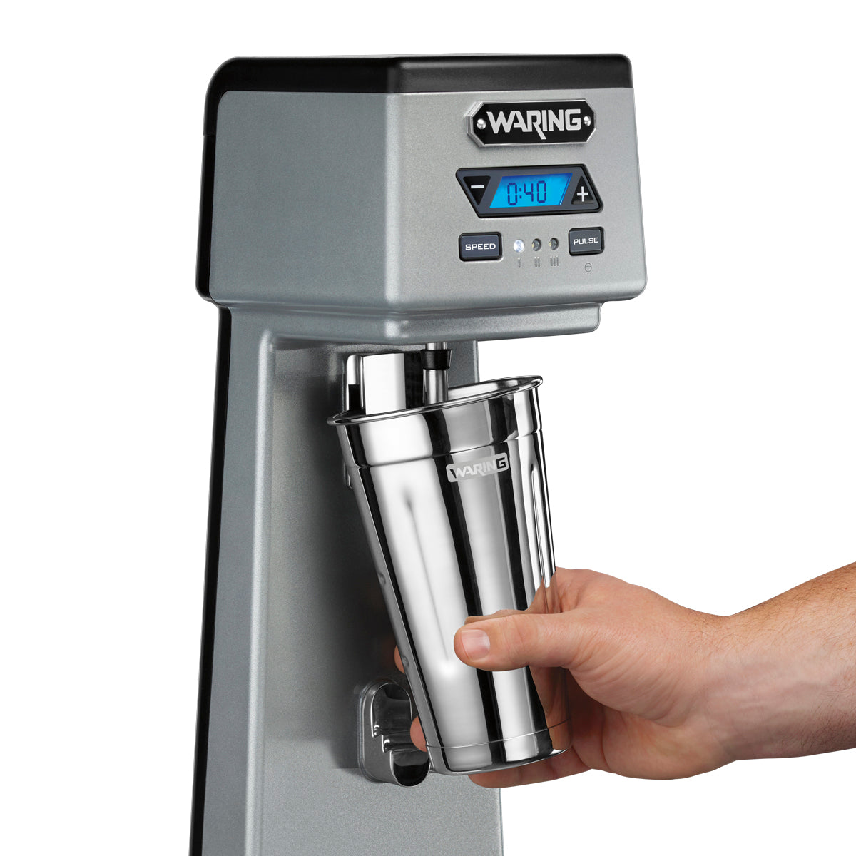 Hand sliding a stainless steel malt cup onto the Waring WDM120TX spindle, close-up