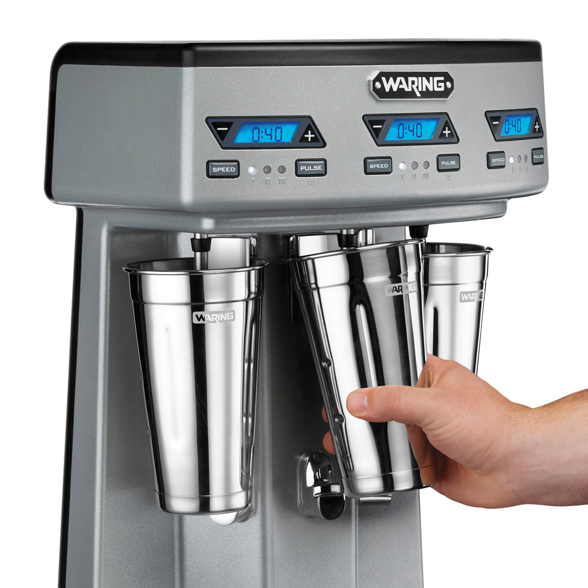 Hand sliding a stainless steel malt cup onto a Waring WDM360TX spindle, close-up