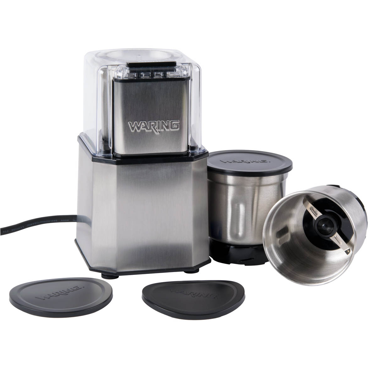 Waring WSG30 spice grinder with cover on, two extra grinding bowls, blade and storage lids