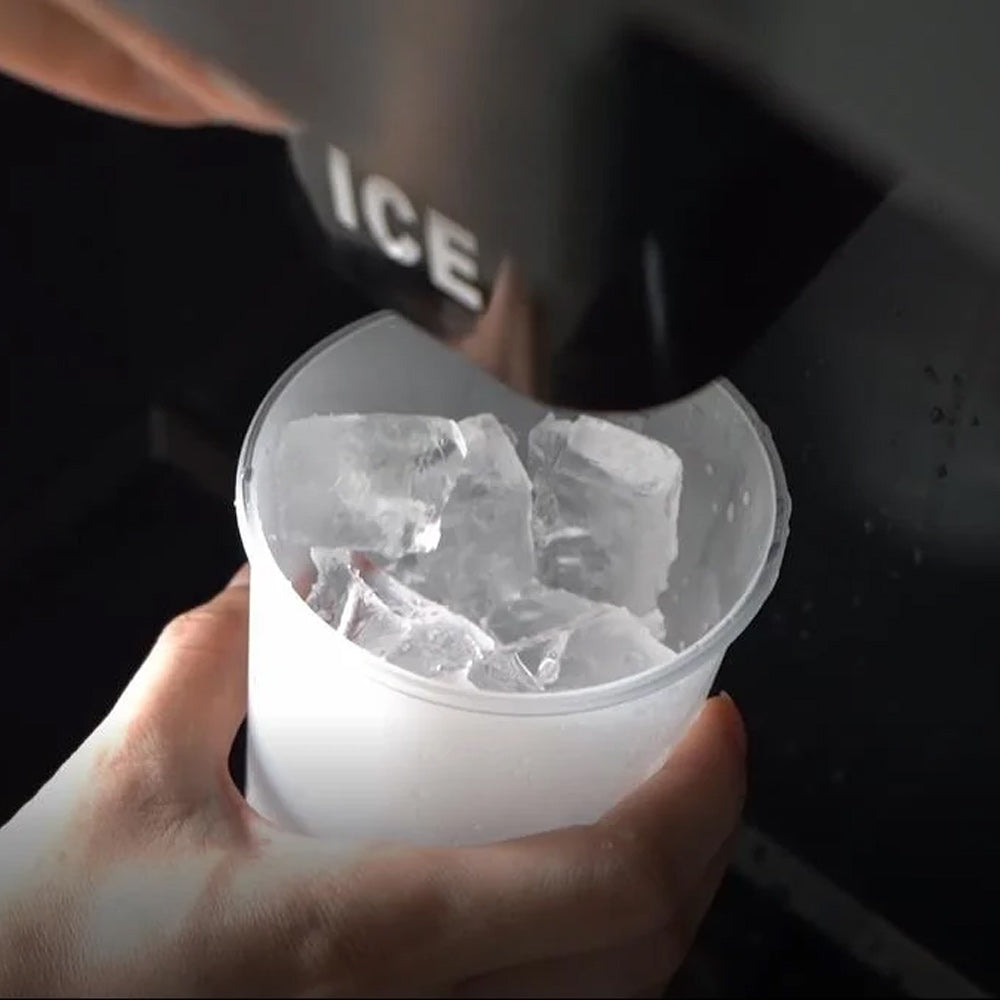 Coldline BD250-30 ice dispensing bin, ice dropping into a cup under the chute, close-up