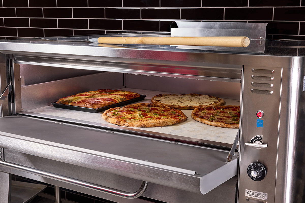Blodgett pizza deck oven with door open and pizzas on the stone deck