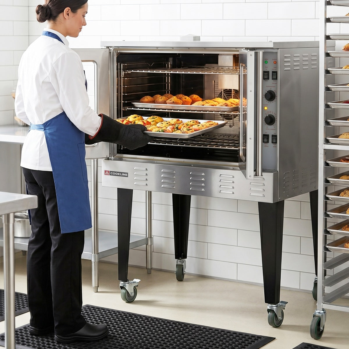 Cookline CC80-NG-SGL deep depth single deck gas convection oven, in use, loading a tray of food in a kitchen