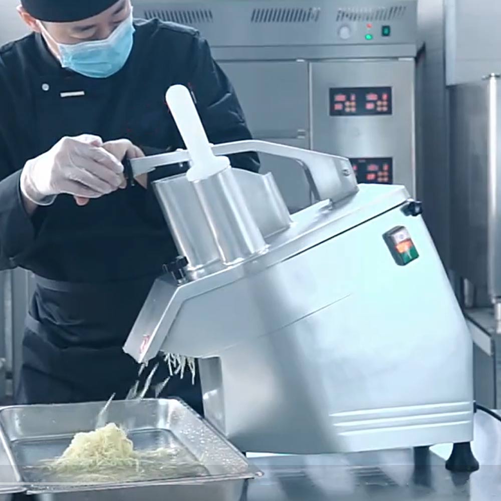Prepline PLC-300 vegetable cutter in use, shredding into a pan in a commercial kitchen
