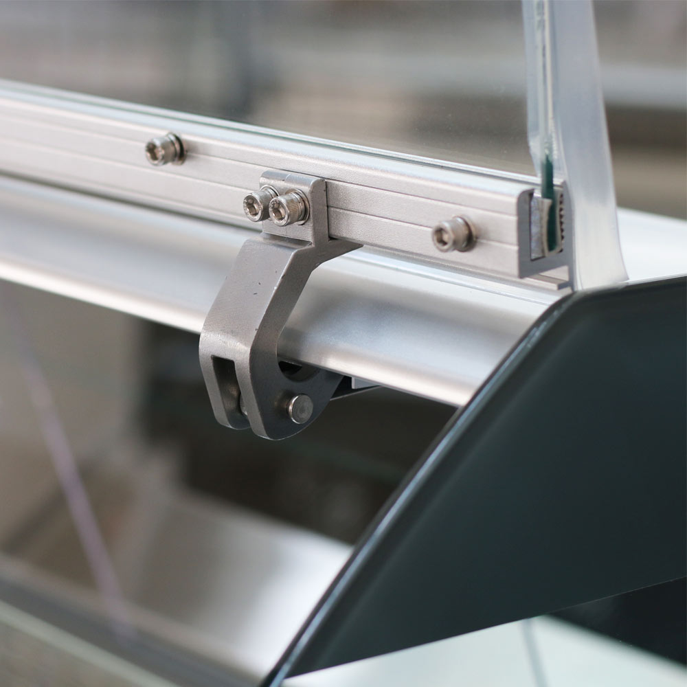 Coldline SDC72 curved glass meat deli case, curved glass hinge, close-up