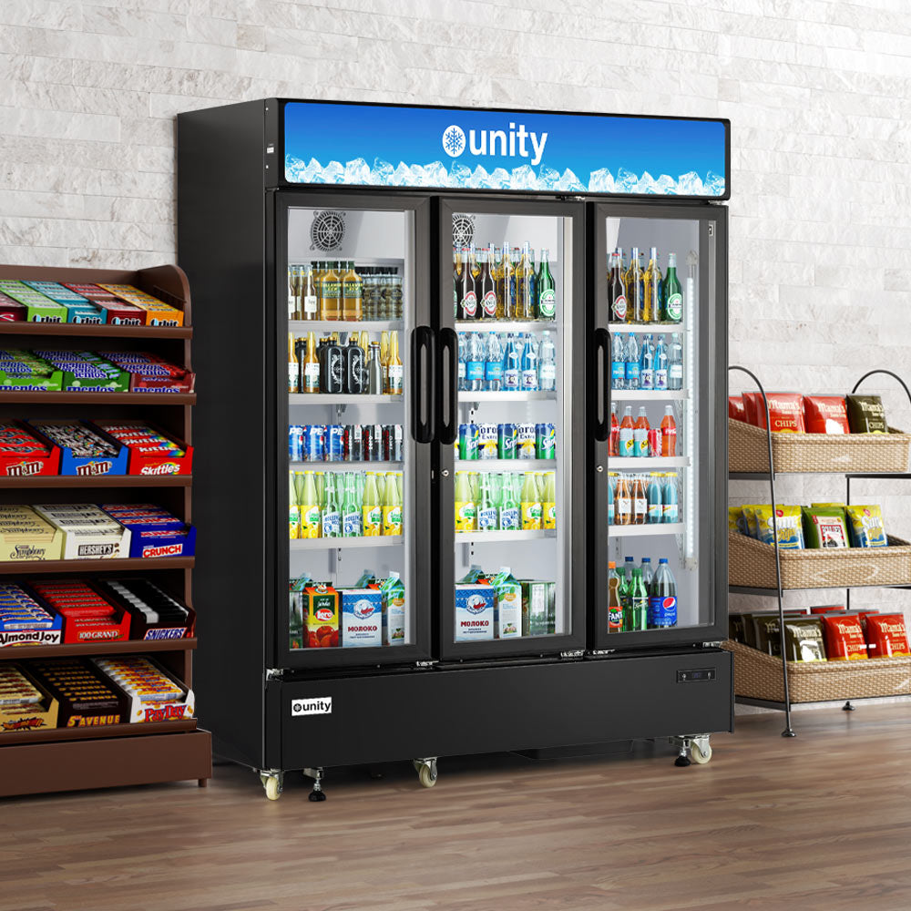 Unity U-72M three glass door merchandiser refrigerator, stocked with drinks in a store